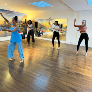 A group of young happy women dancing lady styling in a dance school